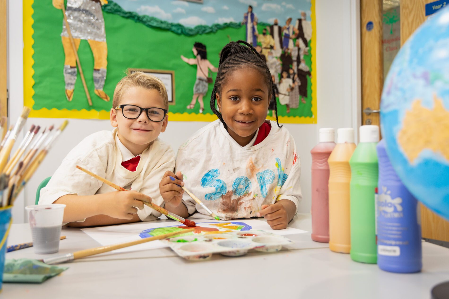 pupils smiling in arts class at st botolphs primary school