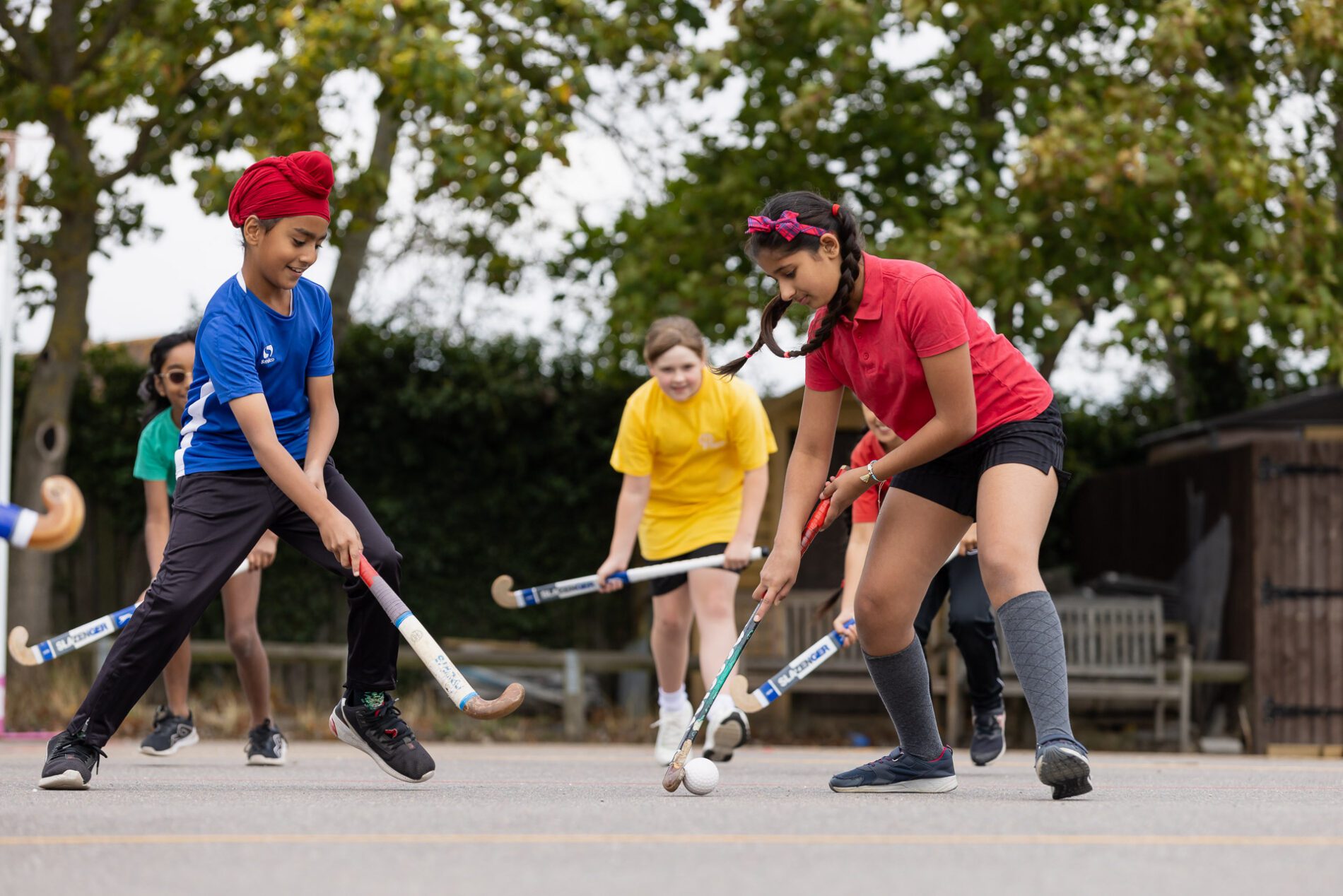 pupils at st botolphs primary school playing hockey